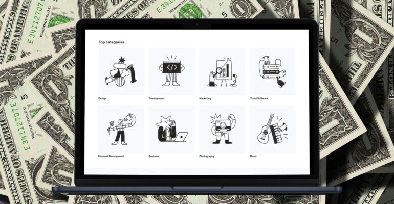 A MacBook Air displaying various skill categories on the screen, with dollar bills in the background